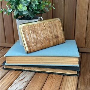 Vintage genuine leather clutch with gold-tone kiss-lock closure.